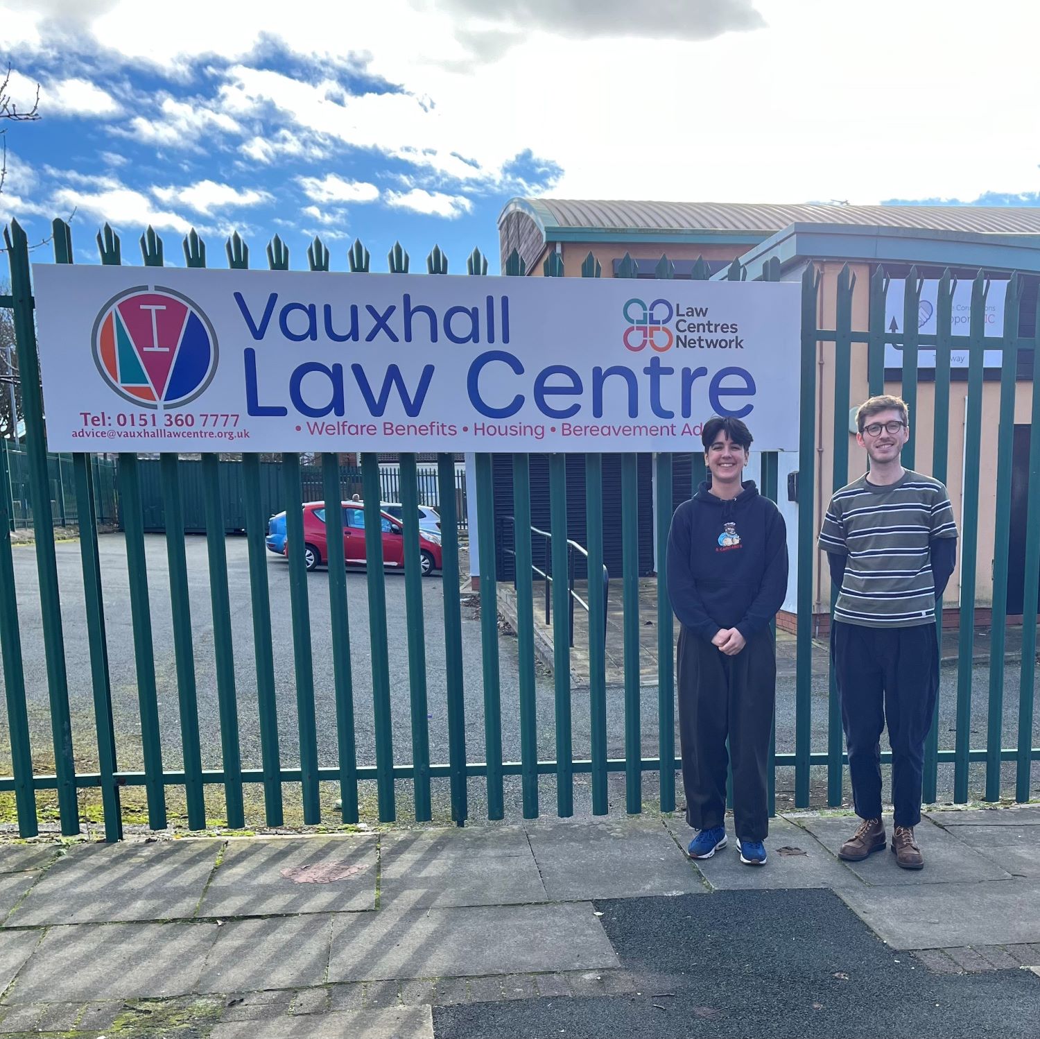 Two people standing outside a building
