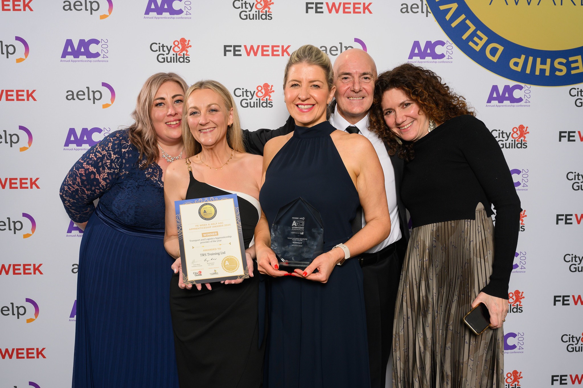Five members of TRS holding their award