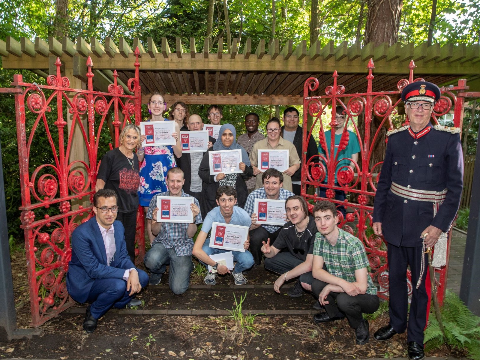 Group of young adults pictured holding certificates