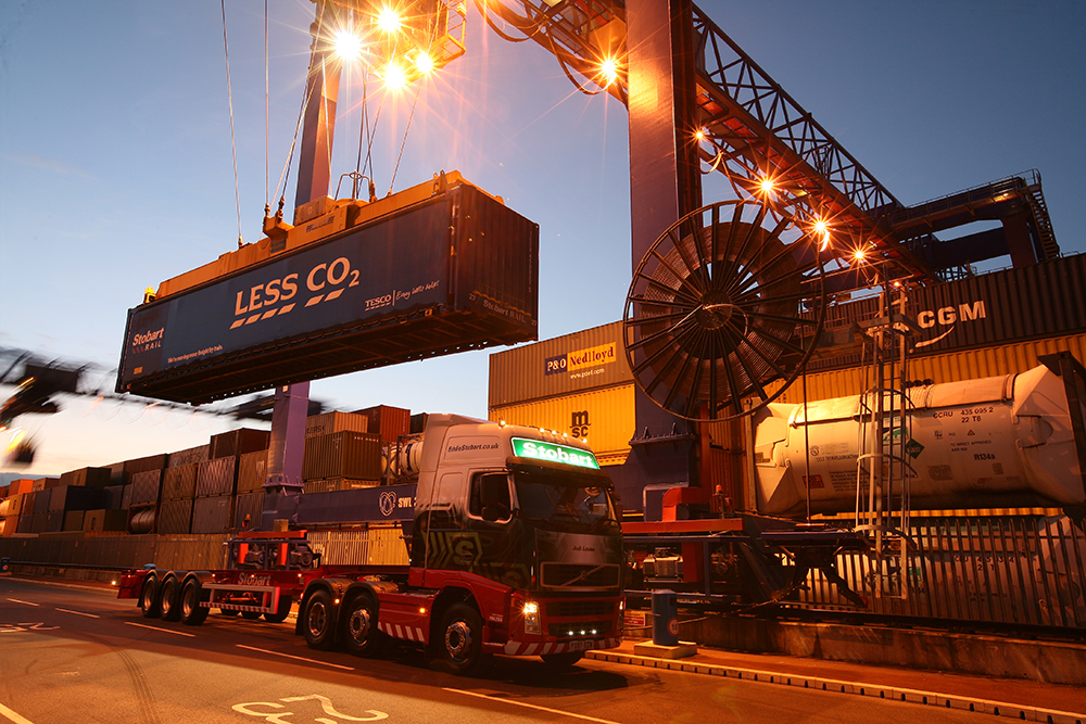 Freight container being lowered onto transporter