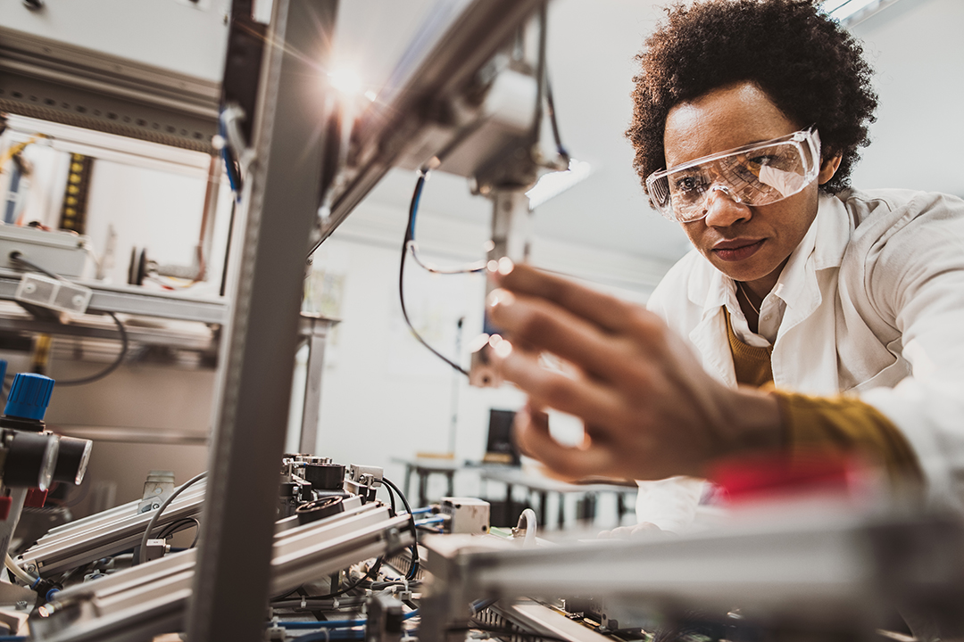 Female engineering student working with equipment